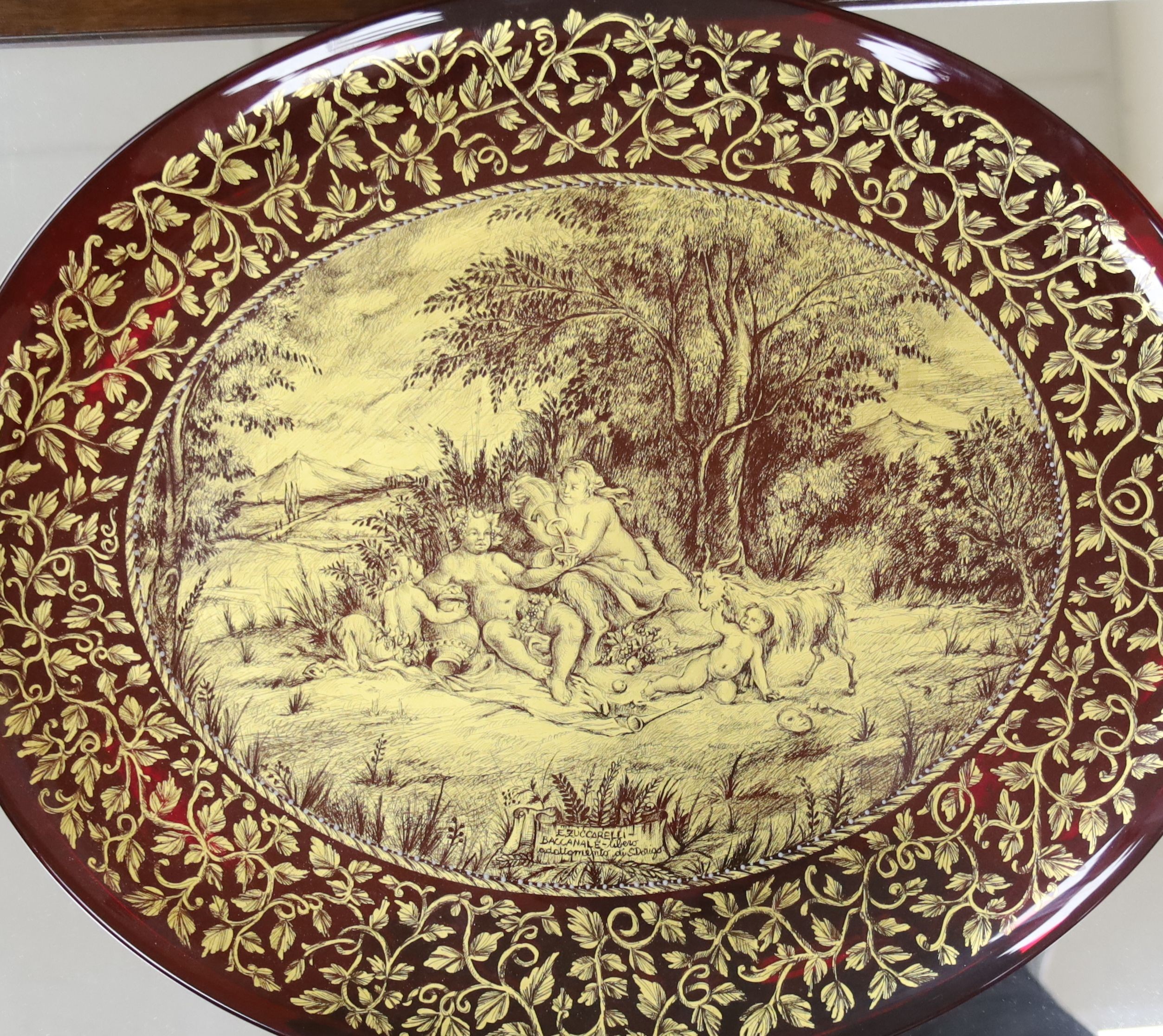 A Murano gilt decorated ruby glass oval dish, signed E. Zuccarelli - Buccanale - liber or adottomdnto Di S.Dorigo. , 46cm with mahogany, case